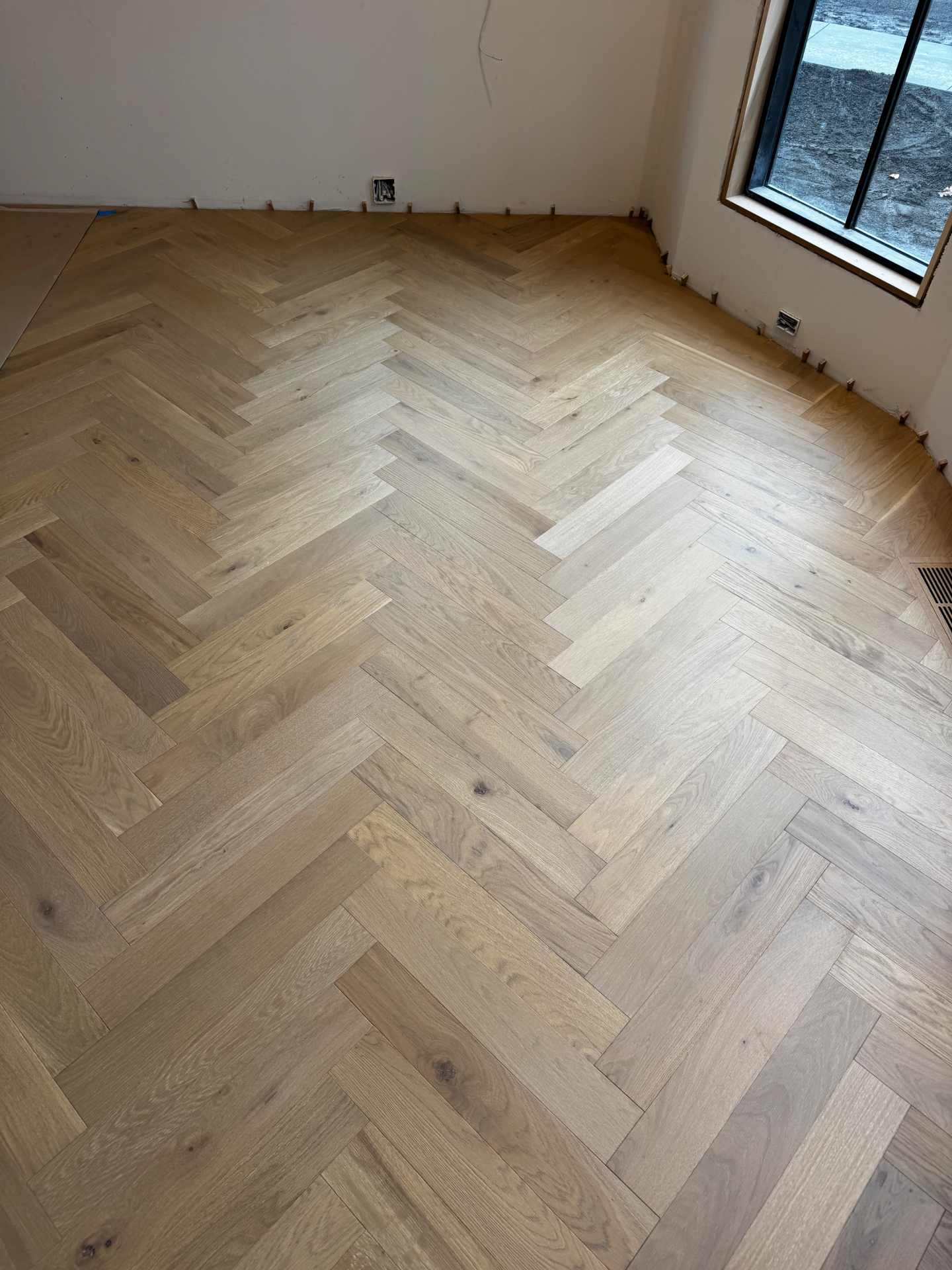 Finished herringbone hardwood floor in a Portland home remodel